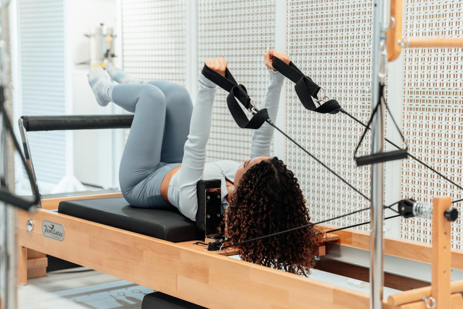 woman on a pilates tower